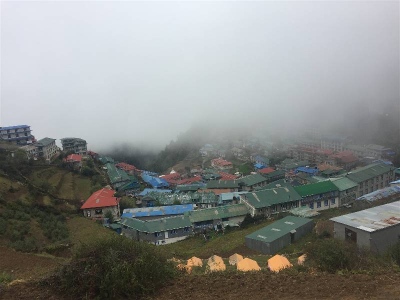 Namche Bazaar is a U-shaped town on a Himalayan mountainside, once Sherpa trading post and now respite for weary trekkers