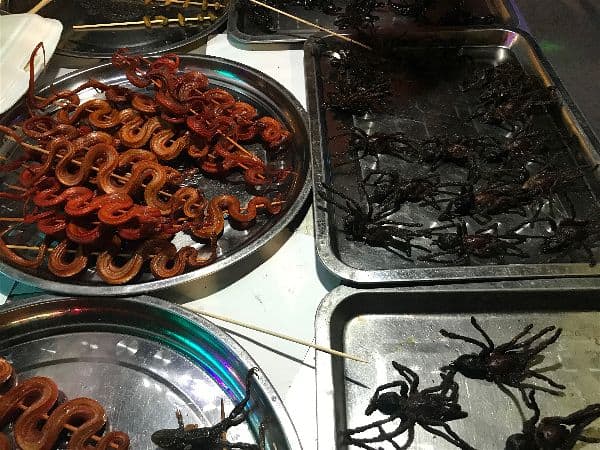 Tarantula - A not so delicious option to taste in Thailand and Cambodia. Notice the optional snake hanging out on that tray too?