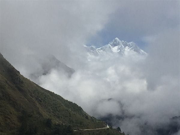 A view of Himalayan peaks cresting above the clouds on the road to the Tengboche monastery