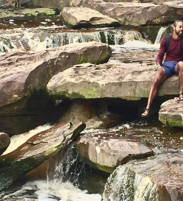 Enjoying a waterfall after hiking with the Xero Z-Trail sandals