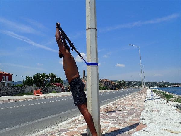 Overhead presses with a suspension trainer recreate the "military press" normally done with free weights, giving a great shoulder and upper chest workout